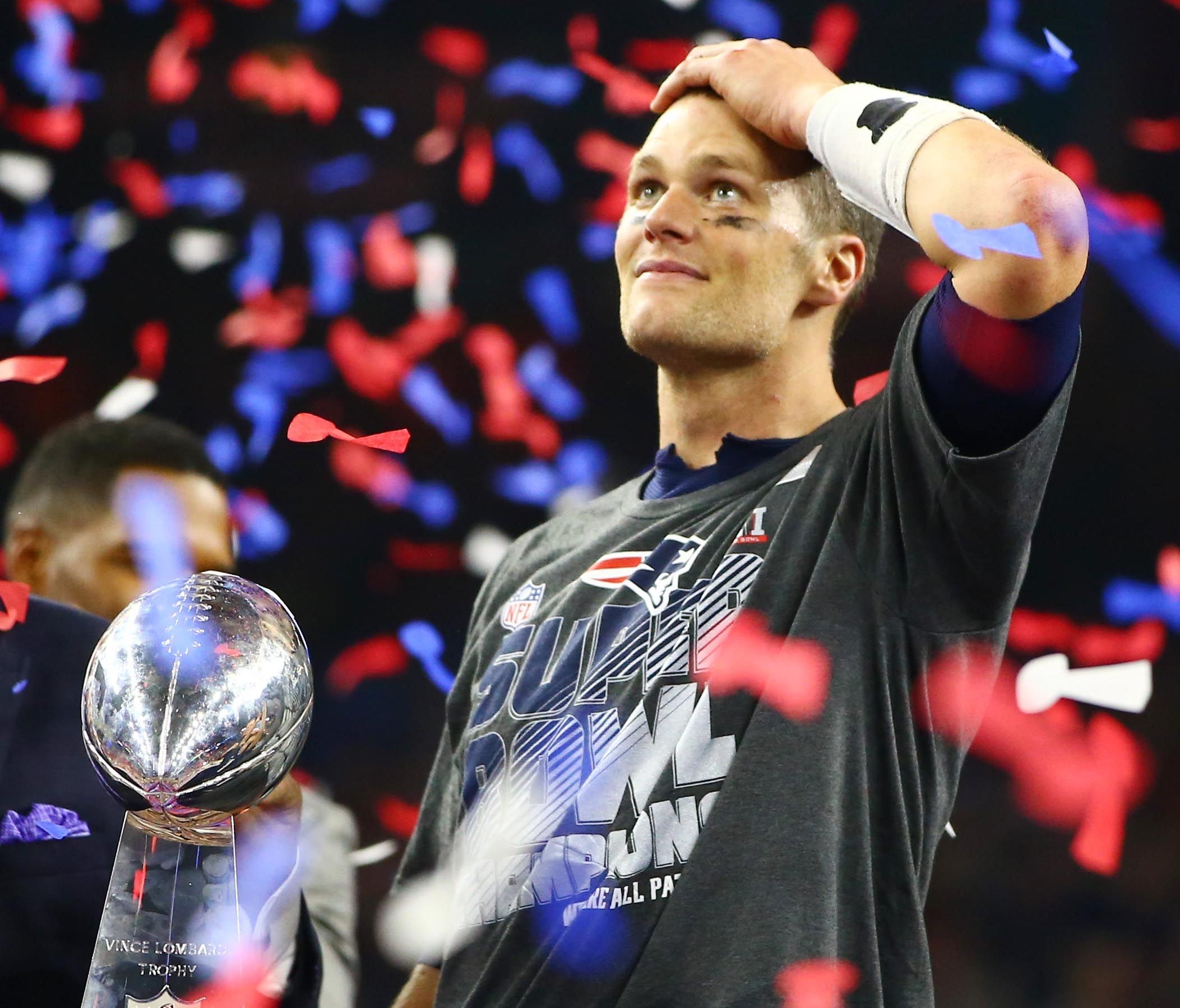 New England Patriots quarterback Tom Brady (12) celebrates with the Vince Lombardi Trophy after defeating the Atlanta Falcons during Super Bowl LI at NRG Stadium.