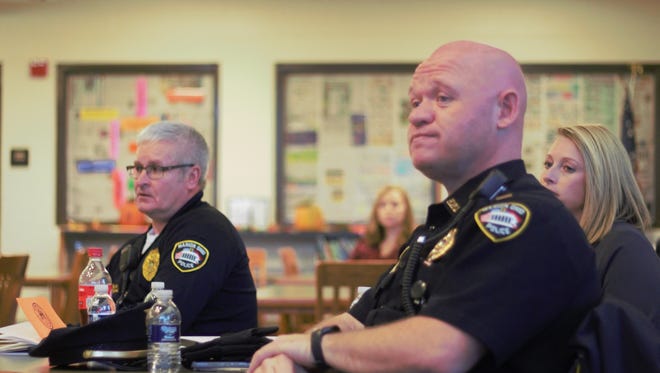 Marion police Lt. B.J. Gruber and other members of law enforcement listen to parents at a safety forum at Grant Middle School.