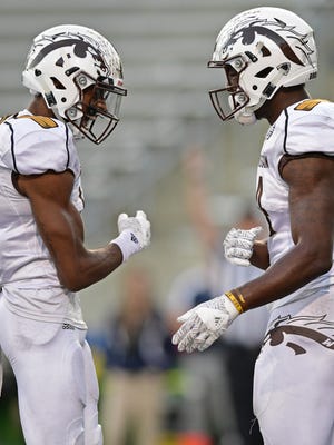 Western Michigan receiver Corey Davis, right, celebrates with receiver Carrington Thompson after scoring a touchdown in the third quarter of the win over Akron Saturday in Akron, Ohio.