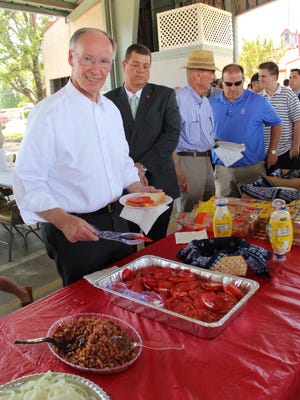 Gov. Robert Bentley makes a tomato sandwich during an annual event that attracted about 250 area residents Tuesday. The governor was so hungry he ate a second sandwich a few minutes later. Others did the same thing.