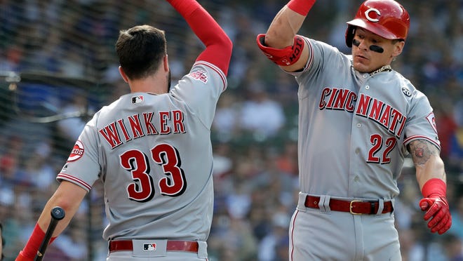 Cincinnati Reds' Derek Dietrich, right, celebrates with Jesse Winker after hitting a solo home run against the Chicago Cubs during the eighth inning of a baseball game Saturday, May 25, 2019, in Chicago. (AP Photo/Nam Y. Huh)