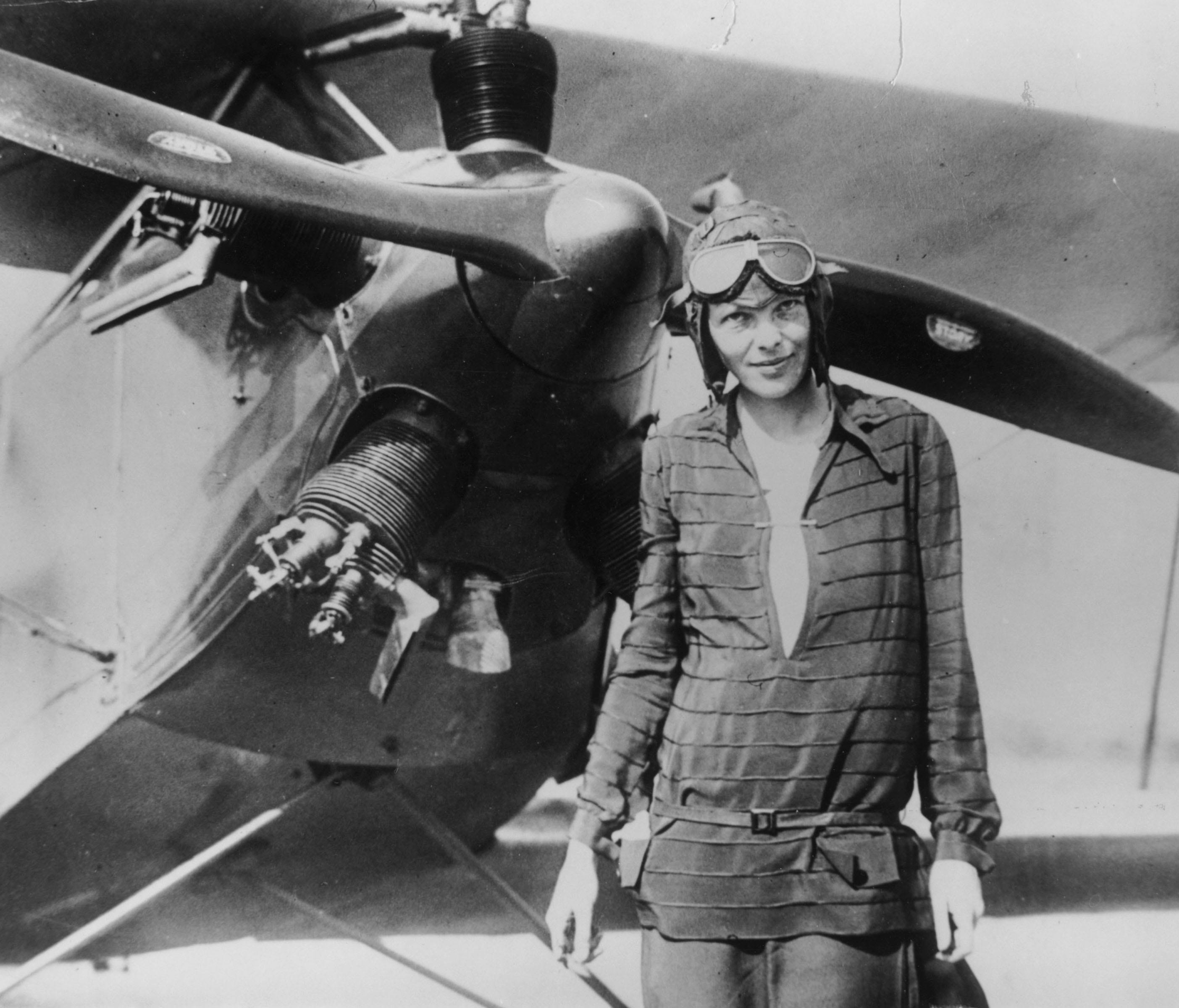 Amelia Earhart  in front of her bi-plane called 