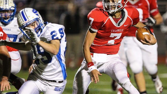 Dixie QB Drew Moore carries the ball during the second quarter against Simon Kenton on Friday night.