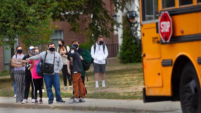 Spaulding High School students wait for a ride after being dismissed Sept. 18, 2020, due to a positive COVID-19 case. Cases of the virus in the city of Rochester's schools are now being tracked on a new school district online dashboard.