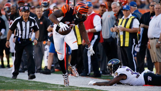 Bengals wide receiver Mohamed Sanu tiptoes on the line after a reception against the Ravens on Sunday.