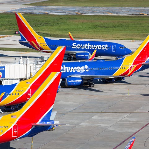Several Southwest Airlines planes in an airport ga