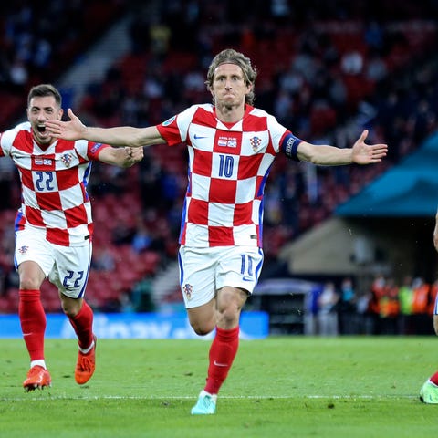Croatia's Luka Modric, center, celebrates after sc