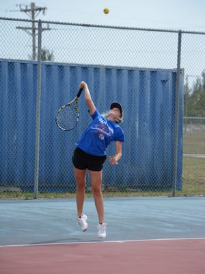 Cape Coral's Yevheniya Krasynska serves during her regional semifinal match on Tuesday.