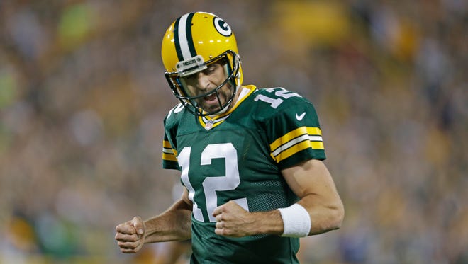 Green Bay Packers quarterback Aaron Rodgers (12) celebrates a touchdown catch by James Jones (89) against the Seattle Seahawks.