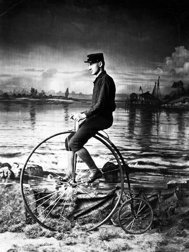 Norman B. Conger rides a bicycle called an Ordinary