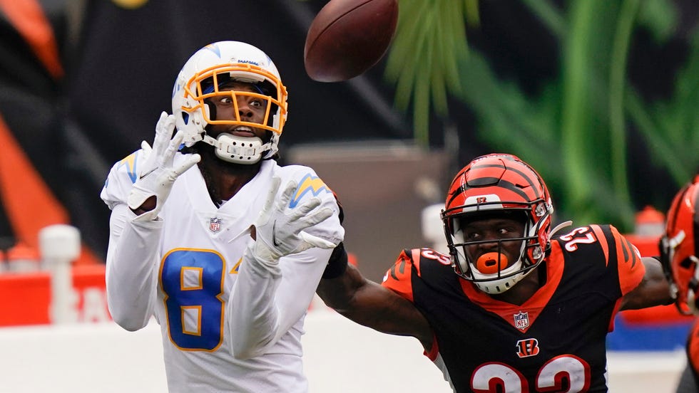 Los Angeles Chargers' Mike Williams (81) makes a catch against Cincinnati Bengals' Darius Phillips (23) during the first half of an NFL football game, Sunday, Sept. 13, 2020, in Cincinnati. (AP Photo/Bryan Woolston)