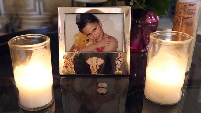 A photo of Samantha Aguilar is on a table in the family's living room.