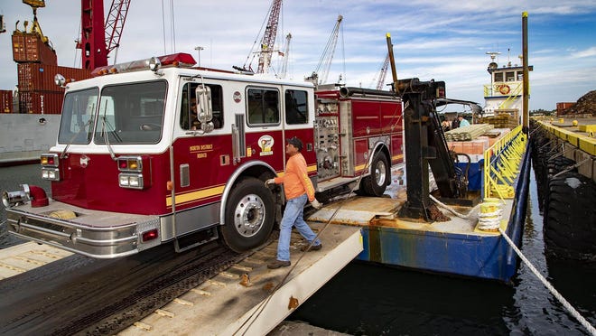 A Vietnam-era landing craft with supplies, including a fire engine, is loaded for the Bahamas from the Port of Palm Beach in West Palm Beach, Feb. 7, 2020. The landing craft will deliver supplies to Coopers Town, which was devastated by Hurricane Dorian five months ago. "One of the biggest needs is a fire truck," says Scott Lewis, Eagles Wings? Foundation founder and President. "Resident have been fighting house fires with five-gallon buckets." The 100-foot long vessel acquired by the West Palm Beach-based Eagles? Wings Foundation is being used to transport the fire engine and 130 tons of relief supplies to help rebuild a school in the North District. The vessel   will be used to ferry supplies between islands where sloping beaches can deter deeper draft ships.