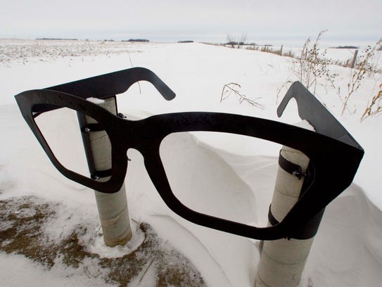 A giant pair of Buddy Holly eyeglasses marks the roadside