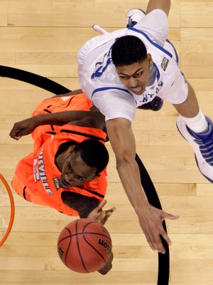 Kentucky forward Anthony Davis, top,  tries to block a shot by Louisville guard Russ Smith (2) during the second half of an NCAA Final Four semifinal college basketball tournament game Saturday, March 31, 2012, in New Orleans. (AP Photo/David J. Phillip)