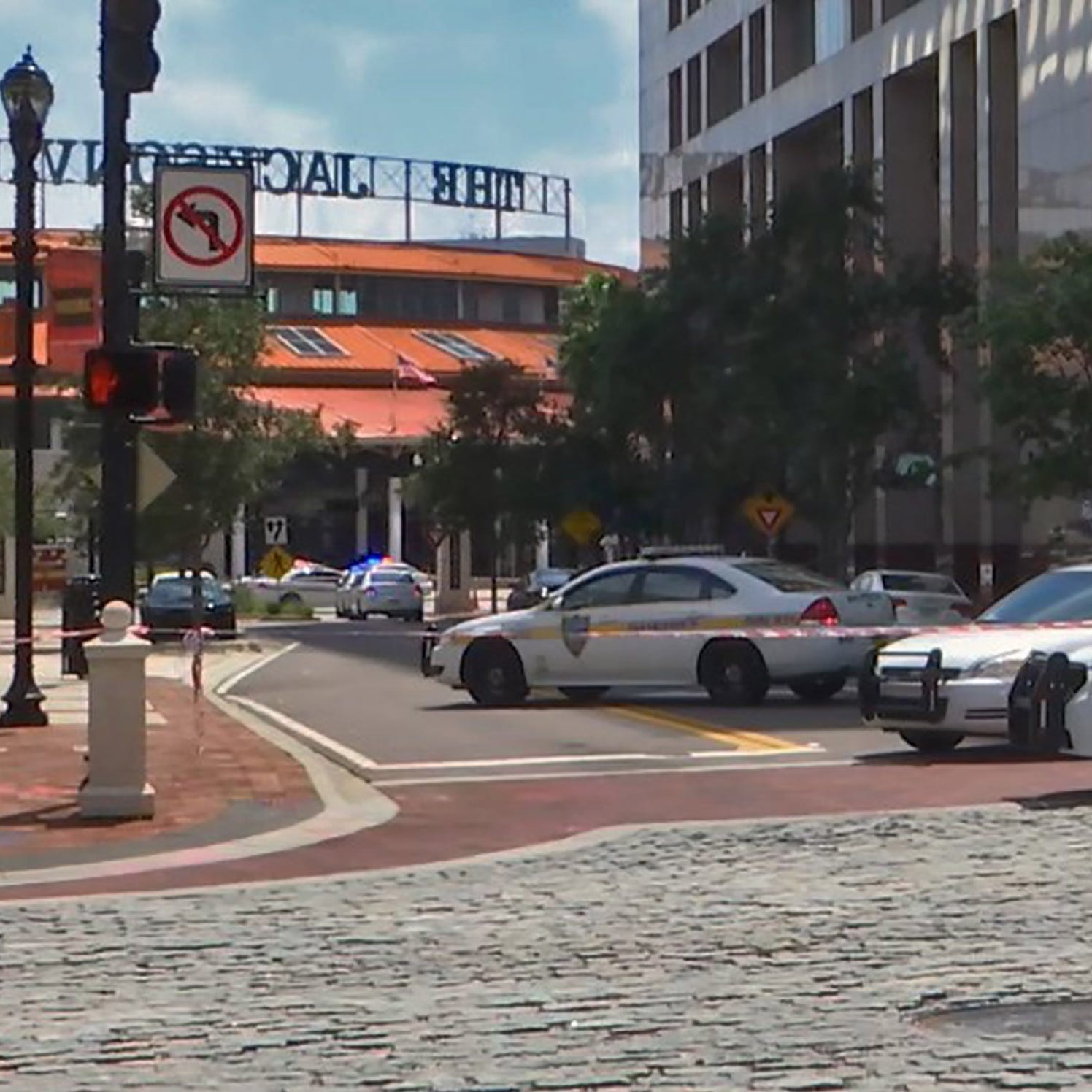 This handout image distributed courtesy of WJXT, a local Jacksonville television station, shows police cars blocking a street leading to the Jacksonville Landing area in downtown Jacksonville, Florida, August 26, 2018. Several people have been killed