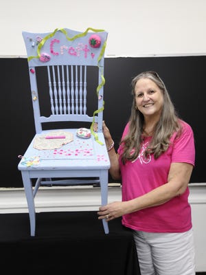 Kathi Arbree, a participant in the Pink Chair Project sponsored by Jupiter Medical Center and the Margaret W. Niedland Breast Center, displays her pink chair, which highlights her love of crafting.