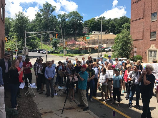 Alyssa Bradley of Clean Water Action speaks to a group of environmental advocates protesting proposed EPA cuts outside the Morristown office of Rep. Rodney Frelinghuysen