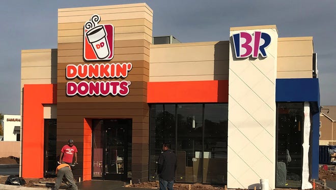 Construction crews work to complete construction on the soon to be finished Dunkin Donuts/Baskin Robbins restaurant located near the 4600 block of Kemp Boulevard Monday afternoon.