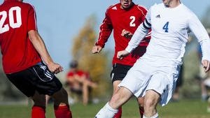Bison forward James Mitchell fights for the ball against Bozeman on Saturday at Siebel Soccer Park