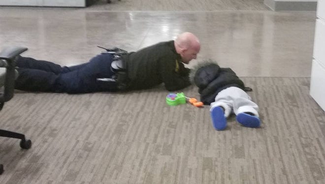 Officer Will Nastold pictured with the boy found wandering the streets overnight Tuesday.
