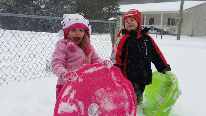 Lily, 3, and Jacob Moreno, 6, of Ocean City, are all smiles during the first snowstorm of 2017. Their sleds were a gift, purchased by an anonymous man when their mother didn't have quite enough money on her to buy them.