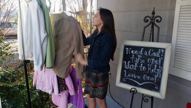 Maddie Harter, 14, set up a coat rack outside of the Shop of Pleasant View for a community service project.