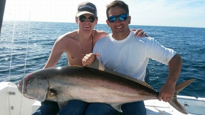 Captain Rick Barberi and mate Griffin Wilson of Marlin Hunter Fishing Charters with a nice amberjack they caught fishing off Pensacola.