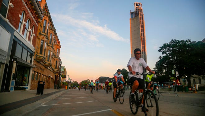 Riders roll out of Jefferson on the third day of RAGBRAI in 2018. The Mahanay Memorial Carillon Tower is the town's main landmark.