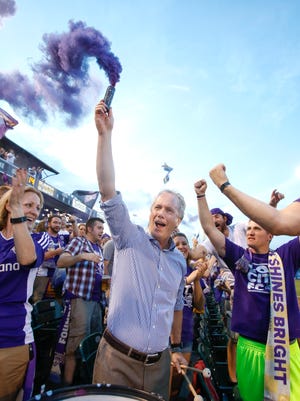 Louisville's Mayor Greg Fischer gets the crowd going with a smoke grenade after Louisville City FC scored their first goal against Charleston.Aug. 22, 2015