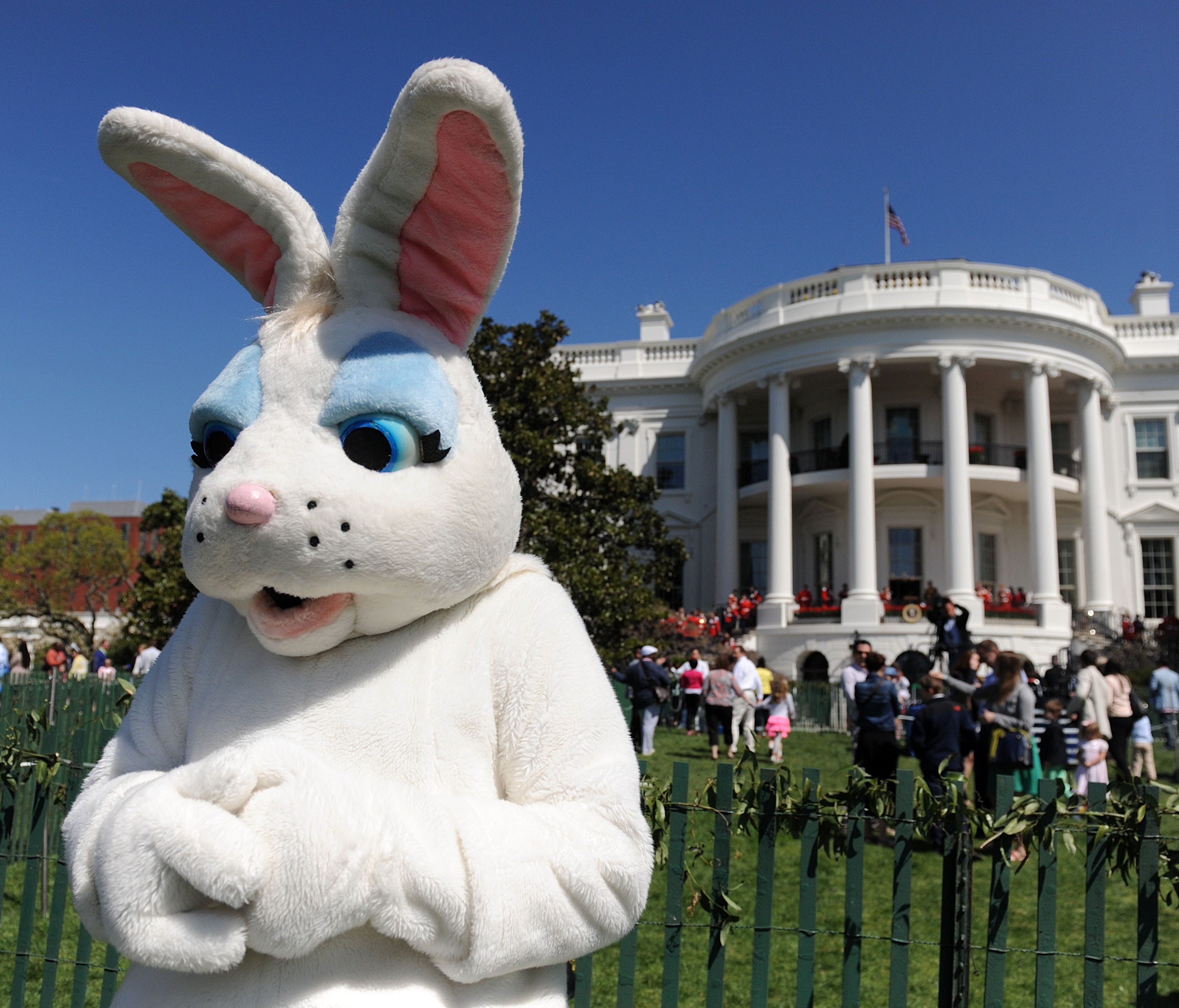 A person dressed as a Easter bunny watches children participate in the annual White House Easter Egg Roll on the South Lawn April 21, 2014 in Washington, DC.