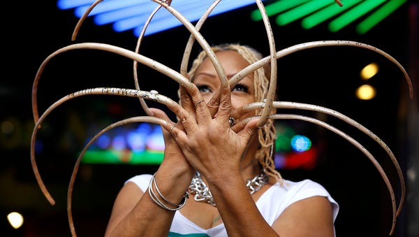 Ayanna Williams displays her 23-inch nails at a bo