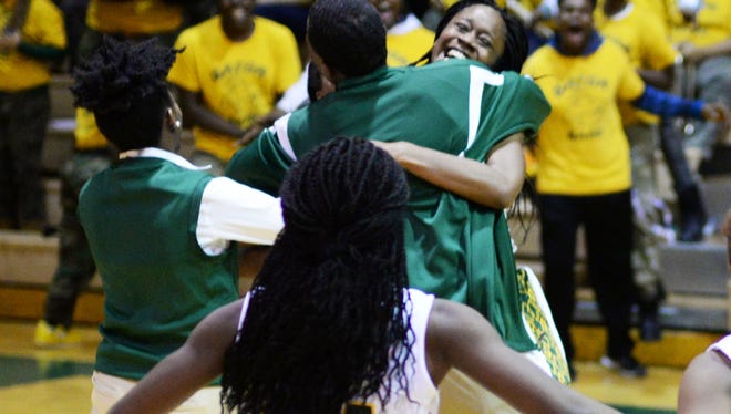 Captain Shreve's coach runs to his teammates as they pull a victory from Evangel seconds before the end of the game Tuesday evening.  