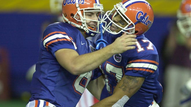 Florida quarterback Rex Grossman, left, and Reche Caldwell celebrate a touchdown pass for Caldwell from Grossman against Auburn in the first half at the Georgia Dome in Atlanta, Ga., on Saturday Dec. 2, 2000.