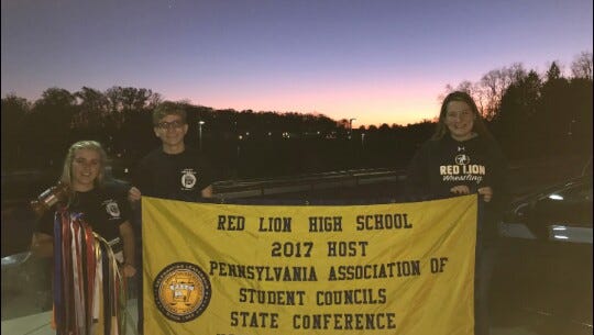 Red Lion students Gianna Dovell, left, the Pennsylvania Association of Student Councils state president, and Jacob Franciscus and Emilee Cutler, co-chairs of the 2017 PASC state conference, hold the official PASC gavel and banner.