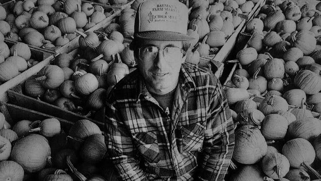 In this 1993 file photo, Jim Bauman, owner of Bauman’s Farm Market, sits among his crop of pumpkins. At the time, Bauman called that year’s crop “probably the best quality pumpkins I’ve ever had.”