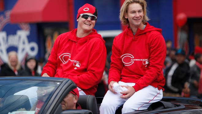 Mat Latos (left) and Bronson Arroyo ride in a car during the 2013 Opening Day parade.