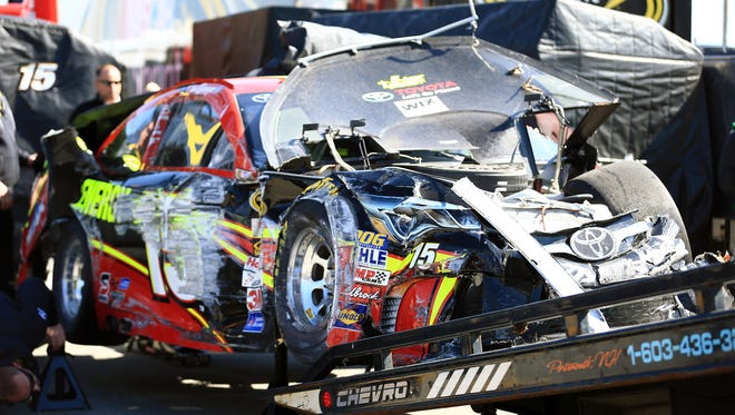 Clint Bowyer's car is loaded on the hauler after he was caught up in a wreck in qualifying for the Daytona 500 pole.