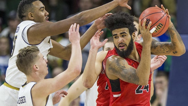 Ball State's Trey Moses (24) gets pressure from Notre Dame's Bonzie Colson, left, and Rex Pflueger during the second half of an NCAA college basketball game Tuesday, Dec. 5, 2017, in South Bend, Ind. Ball State beat Notre Dame 80-77.