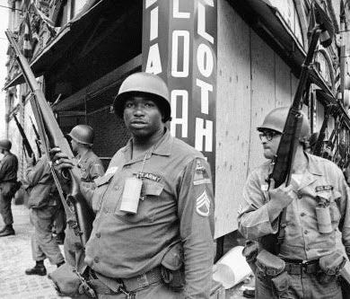 In this July 14, 1967, file photo, National Guardsmen stand at the corner of Springfield Avenue and Mercer Street in Newark, where days of violence and looting came to be known as the Newark riots.