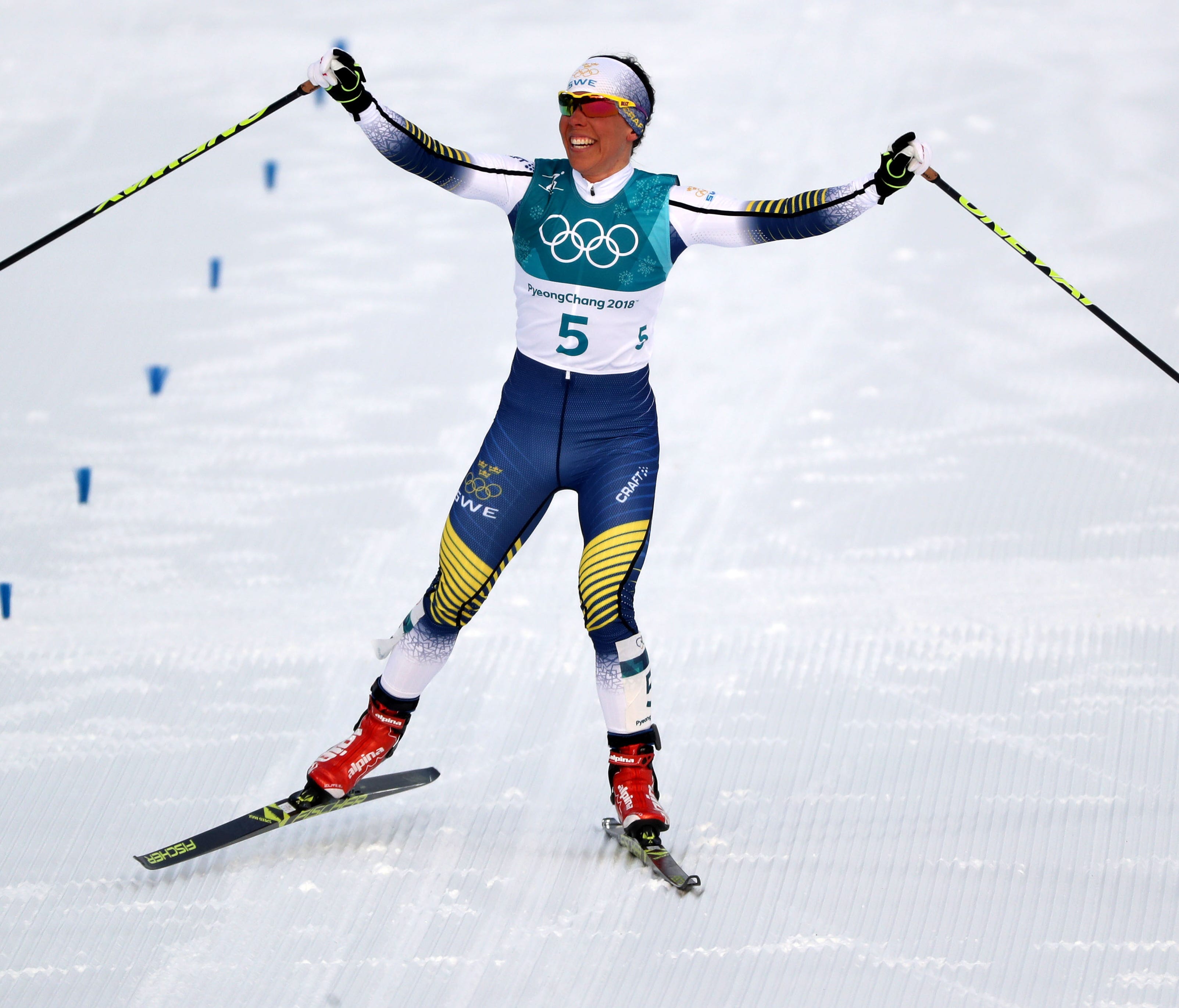 Charlotte Kalla of Sweden celebrates the win in the cross-country skiing 15K, the first medal of the Winter Olympics.