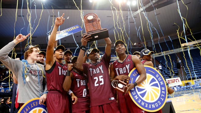 Troy celebrates with their trophy after defeating Texas State in the Sun Belt Conference NCAA college basketball championship game in New Orleans, Sunday, March 12, 2017. Troy won 59-53. (AP Photo/Gerald Herbert)