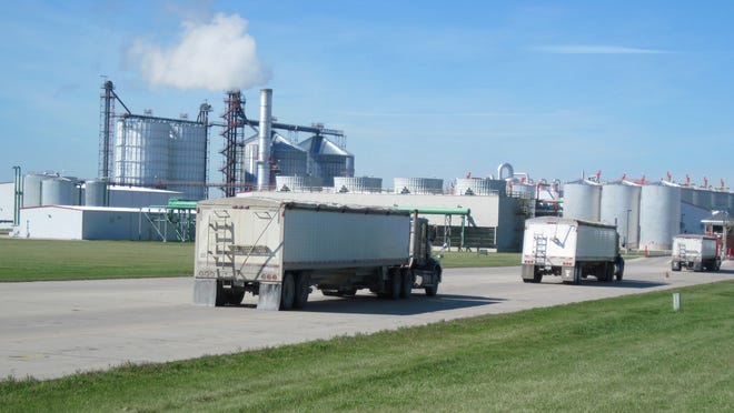 Grain trucks arrive at Absolute Energy, an ethanol plant near St. Ansgar, Iowa, in 2011.