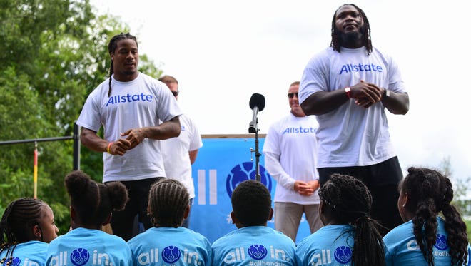 Former FSU and current Atlanta Falcons running back Devonta Freeman (left) and teammate Courtney Upshaw (right) collaborated with Allstate to rebuild a community garden at the Boys and Girls Club of Metro Atlanta.