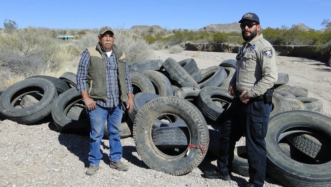 Recently dumped tires are seen here in an arroyo near Doña Ana; pecan farmer Tom Chavez reported the illegal dumping and Codes Enforcement Officer Kevin Apodaca responded to gather evidence and document the site.