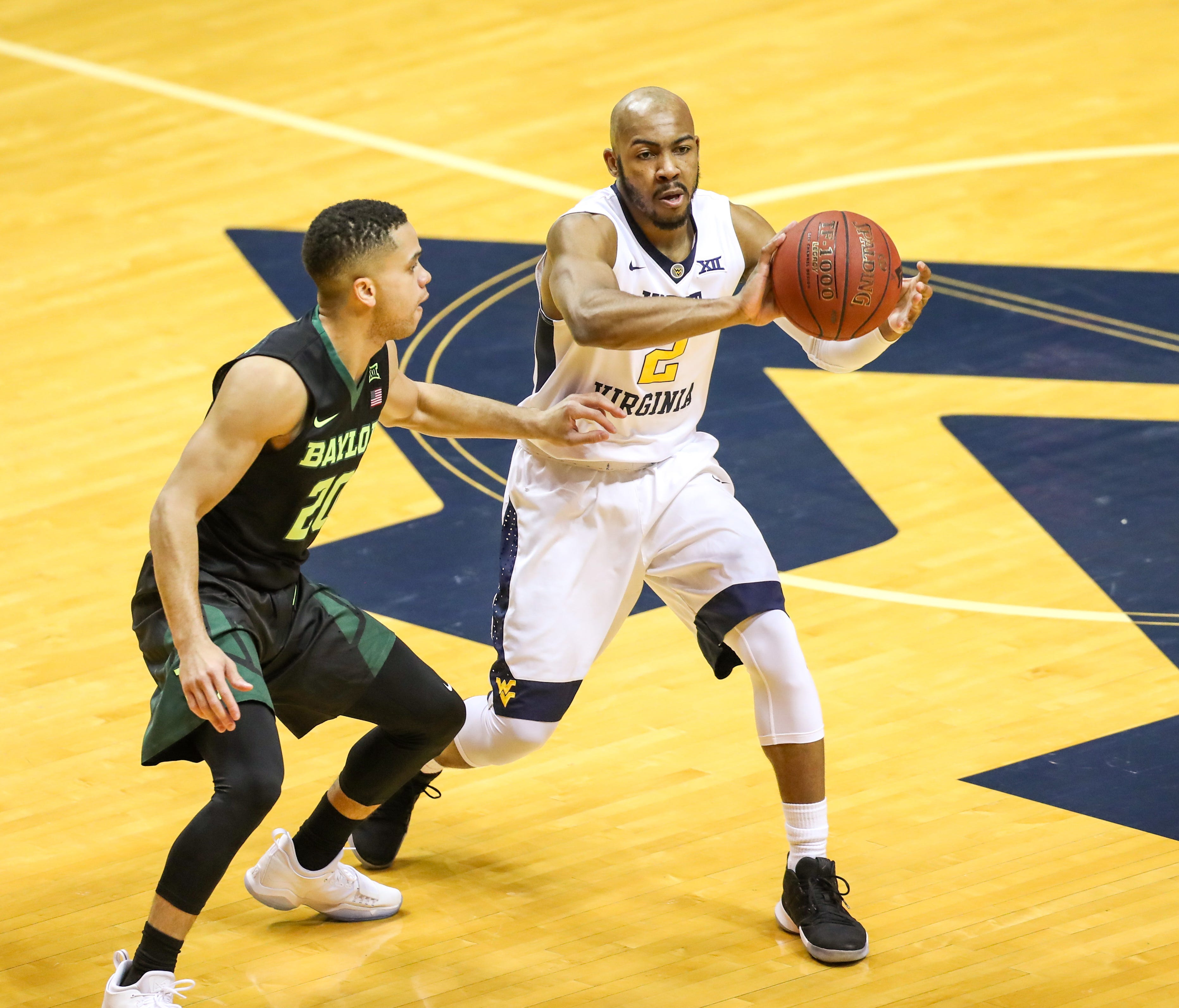 West Virginia guard Jevon Carter passes the ball during the first half against Baylor.
