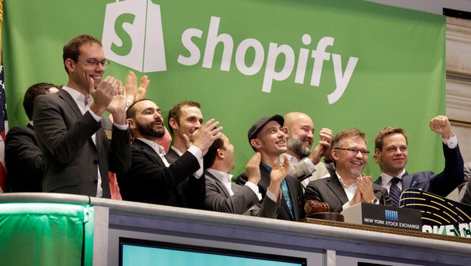 Shopify CEO Tobias Lutke, center wearing hat, is celebrated as he rings the New York Stock Exchange opening bell on Thursday.