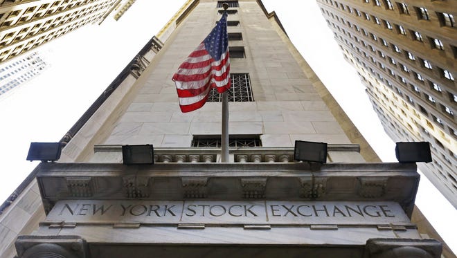 The American flag flies above the Wall Street entrance to the New York Stock Exchange.