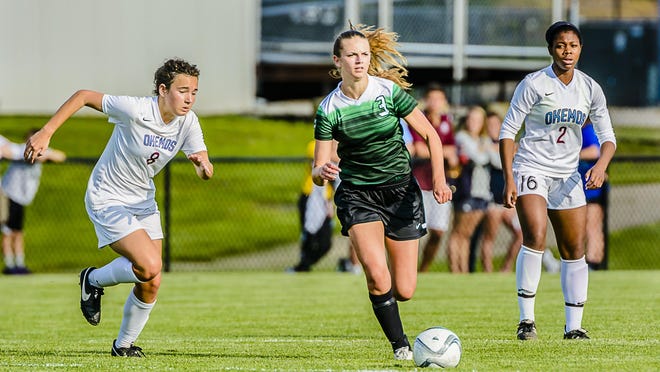 Renee Sturm ,center, of Williamston pushes the ball toward the Okemos gaol between Veronica Gawarecki ,left and Bria Telemaque ,right, of Okemos during their CAAC Gold Cup semifinal game Thursday May 19, 2016 in Okemos. KEVIN W. FOWLER PHOTO