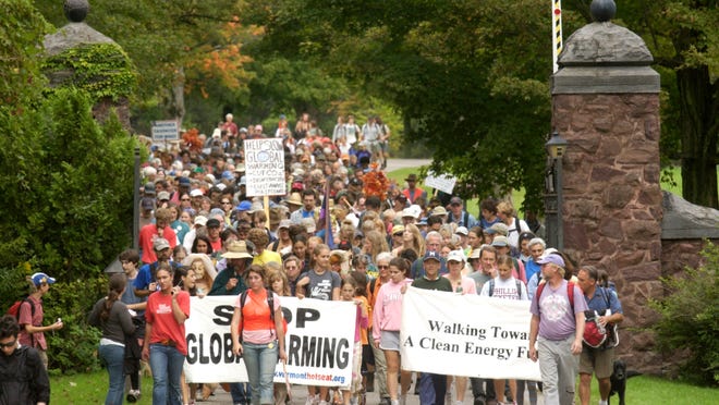 
In a breakout event for 350.org, hundreds of marchers walk through Shelburne in 2006 as part of a five-day walk from Ripton to Burlington to raise awareness about global warming. 
